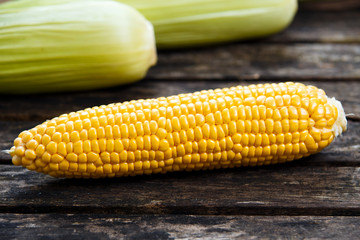Roasted peanuts salted on crumpled paper and old wooden table.