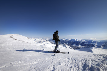 Fototapeta na wymiar Skier on top of ski slope