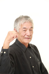 senior Japanese man in a victory pose