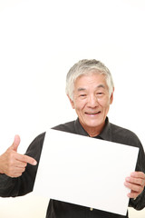 senior Japanese man with message board
