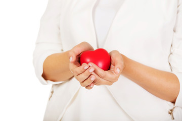 Woman holding heart shaped toy