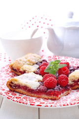 biscuit with raspberries decorated with mint leaf