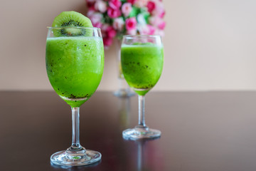 fresh green kiwi juice on wooden table
