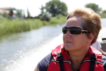 Senior woman resting in boat