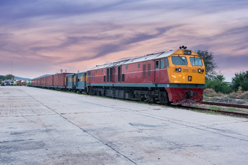 Fototapeta premium Cargo train and container at twilight