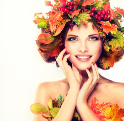 Autumn Beauty - fashion Makeup With Red and yellow autumn Leaves on  girl head . Emotions and...
