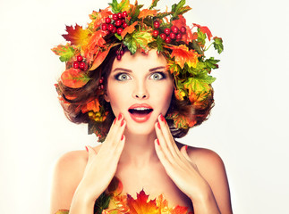 Autumn Beauty - fashion Makeup With Red and yellow autumn Leaves on  girl head . Emotions and...