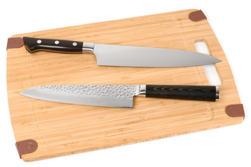 Two knives on a cutting board