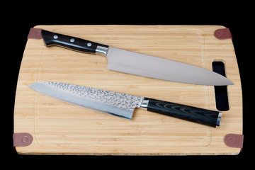 Two knives on a cutting board