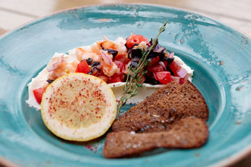 Appetizer of shrimps, tomatoes and sour cream