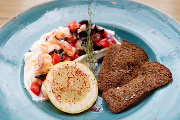 Appetizer of shrimps, tomatoes and sour cream