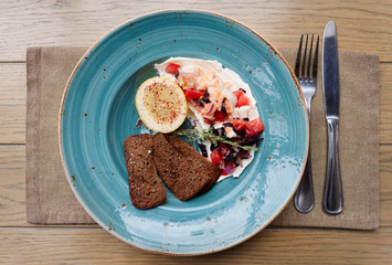 Appetizer of shrimps, tomatoes and sour cream