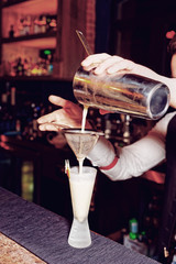 Bartender is making whisky sour