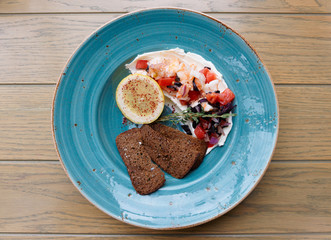 Appetizer of shrimps, tomatoes and sour cream