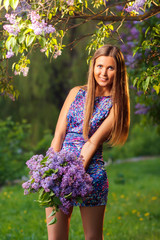 Fashion young woman with lilac flowers