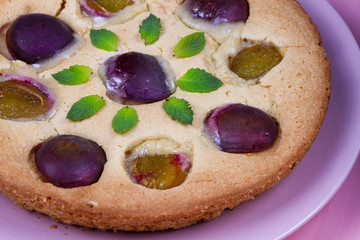 Homemade plum pie, garnished with mint