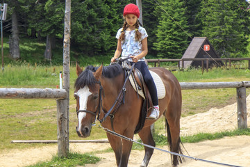 Young girl riding a horse