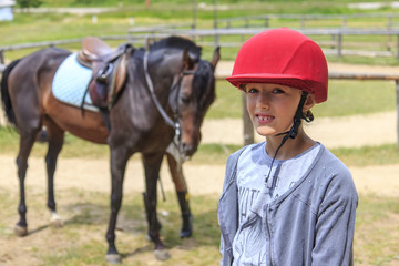 Young girl riding a horse