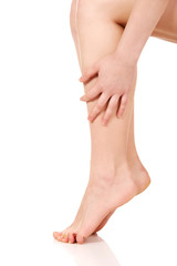 Woman massaging her legs.