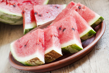 Watermelon slices on a clay plate, selective focus