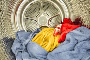 Inside of tumble dryer with drying laundry - 91259044