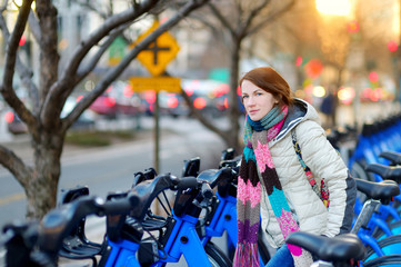 Fototapeta na wymiar Young woman ready to rent a bike in New York