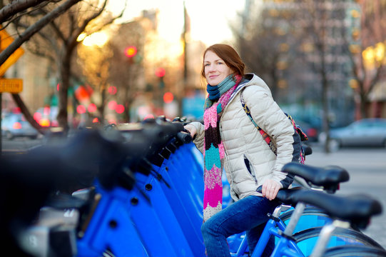 Young woman ready to rent a bike in New York