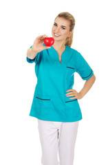 Smiling nurse or female doctor with heart