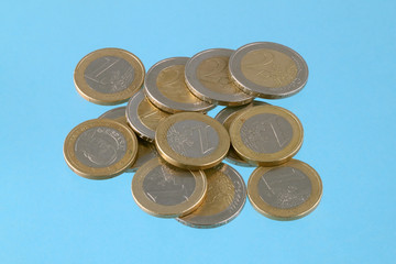 Close up photo of Euro coins on a blue chromakey background