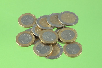 Close up photo of Euro coins on a green chromakey background