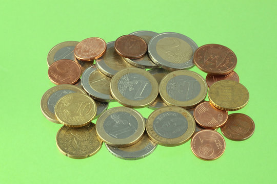 Close up photo of Euro coins on a green chromakey background