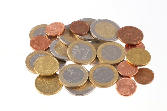 Close up photo Euro coins on a plain white background.