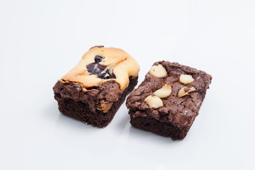 Chocolate brownie with macadamia on white background.