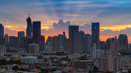 Beautiful sunset in the city of Bangkok with silhouette of office building at front