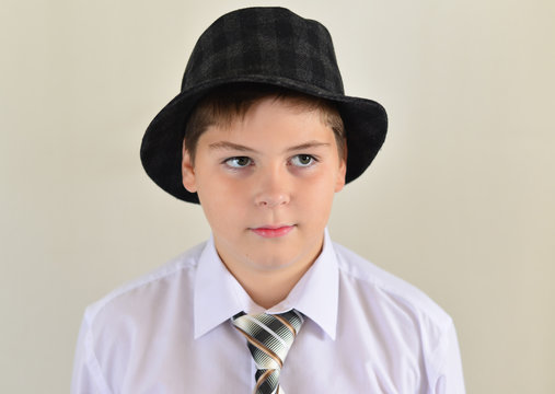 Portrait Of A Teenage Boy In  Hat And Tie