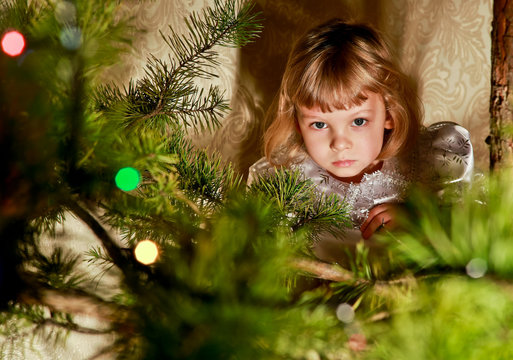 Portrait of a little girl at the Christmas tree