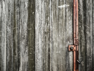 Old wooden door with red lock