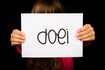 Child holding sign with Dutch word Doei - See you later