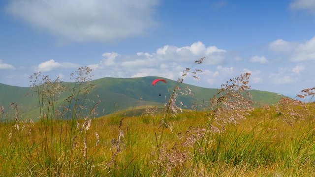 4k,
Paraglider flying high in the mountains
