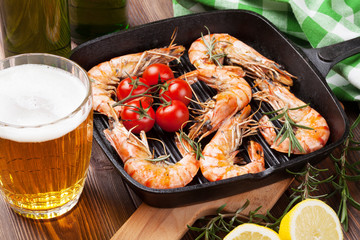 Grilled shrimps on frying pan and beer