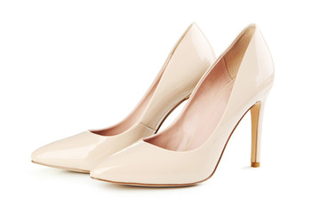 Pair of beige women's high-heeled shoes isolated on a white