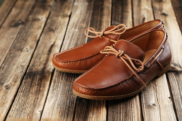 Fashion brown shoes on a brown wooden table