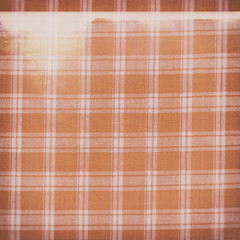 Faded distressed dirty grungy fabric orange and white abstract background wallpaper copy space 