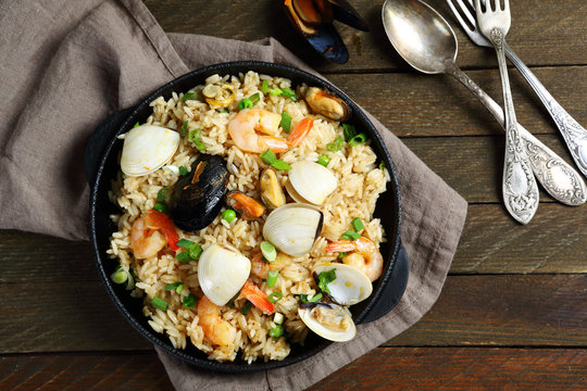 Nourishing paella with seafood in a frying pan