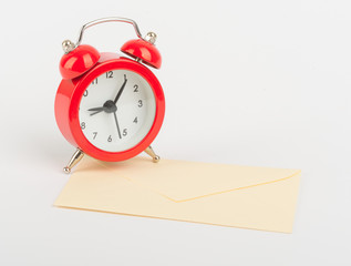 Alarm clock on white envelope