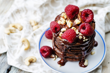 chocolate pancake with bananas, raspberies, nuts and chocolate s