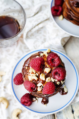 chocolate pancake with bananas, raspberies, nuts and chocolate s