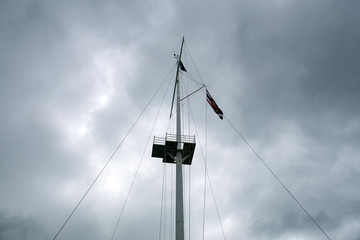 mainmast the midst of a dark hazy sky   