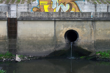 Water pollution in river. Dirty water stems from the pipe polluting the river. Industry not treat water before drain.