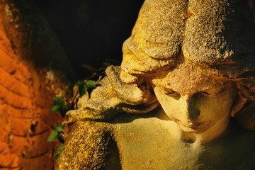 golden angel in the sunlight (antique statue)